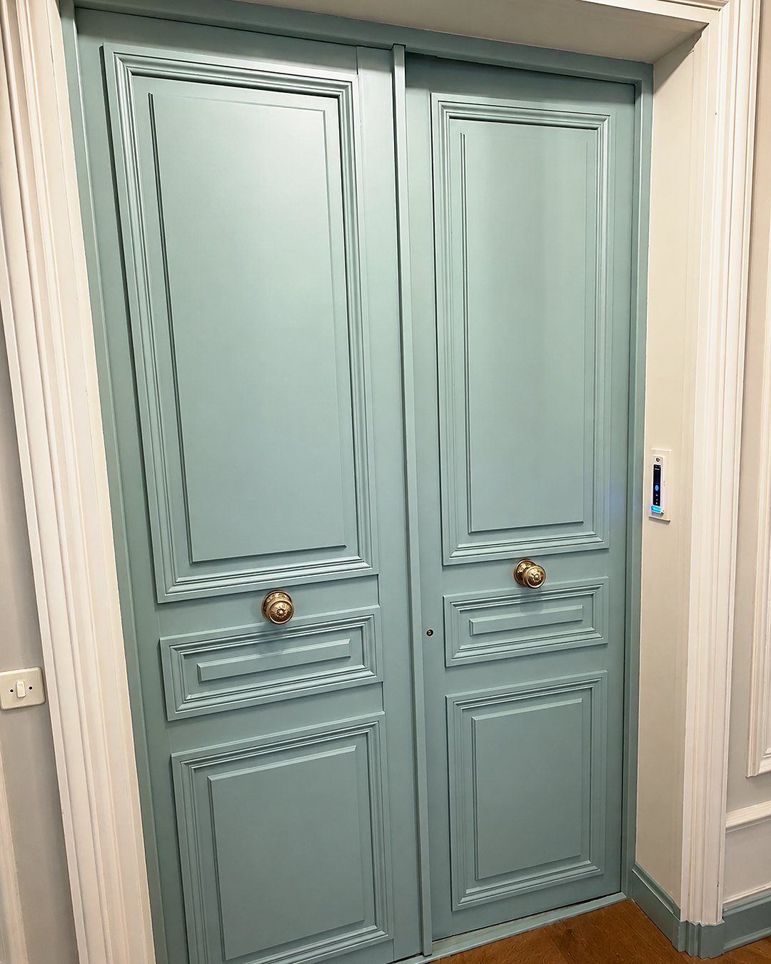 Moulded double security door painted celadon green, brass knobs